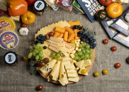 Colorful charcuterie board with assorted cheeses and fresh fruits.